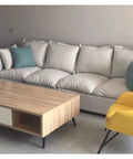 Living room with light sofa, wood table, and chairs featuring Adjustable Aluminum Furniture Legs In Sleek Black, 9.8 Inch Steel Feet.