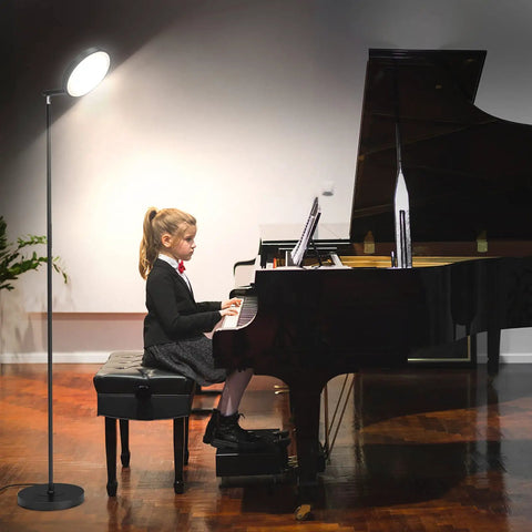 LED Torchiere Floor Lamp With Remote And Touch Control Dimmable Modern Standing Light in black by a girl playing piano