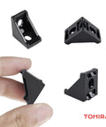 Black 2020 Aluminum T Slot Corner Bracket Kit with 20 right angle connectors shown in hand and different angles