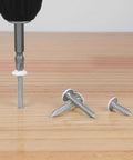 Dang Solid 100 Piece Set Of Size 6 X 5 8 Inch Wood Screws in use with a driver bit on wood surface.