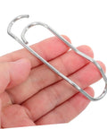 Person holding sturdy metal clip from Plant Trellis Buckles 50 Pack For Garden Fences And Climbing Plants Quick Install And Easy Removal Clips