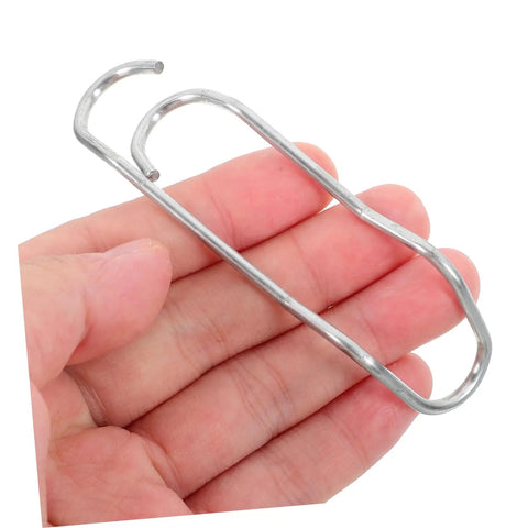 Person holding sturdy metal clip from Plant Trellis Buckles 50 Pack For Garden Fences And Climbing Plants Quick Install And Easy Removal Clips