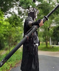 Person holding Hand Forged Longquan Style Dao Sword With High Carbon Steel Blade Full Tang and matte black scabbard outdoors