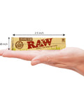 Hand holding King Size Slim Organic Hemp Rolling Papers 4 Pack, 128 Leaves Total; 110 By 44 mm, Ultra Thin, Vegan, Made In Spain.