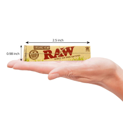 Hand holding King Size Slim Organic Hemp Rolling Papers 4 Pack, 128 Leaves Total; 110 By 44 mm, Ultra Thin, Vegan, Made In Spain.