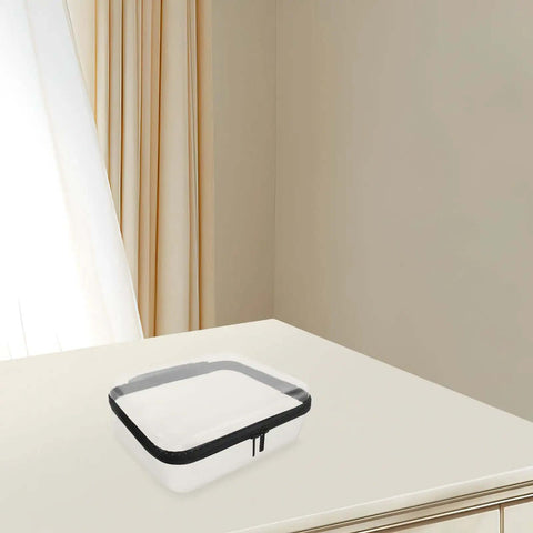 Built Different Clear Hard Shell Zipper Case For Travel Toiletries And Makeup Organizer on a table with a smooth finish.