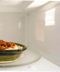 Microwave interior showing installed Mica Waveguide Cover with dish, Microwave Mica Waveguide Cover Insulation Sheets 10 Pack, Heat Resistant.