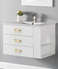 White bathroom vanity with three drawers featuring sleek gold handles.