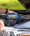 Oil Stop Leak Additive That Actually Seals Leaks Fast, 8 Ounce Bottle For Crankcase And Oil System, Easy Pour, Permanent Seal, Pro Grade Formula For Drips And Leaks, Keeps Your Engine Running Smooth And Clean. Blue bottle pouring into car engine bay