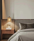 Straight Up Chic Boho Woven Rattan Plug In Pendant Ceiling Light casting warm geometric shadows in a cozy bedroom.