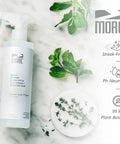 All In One Stone And Quartz Cleaner And Protector Spray For Granite Marble And Quartz Surfaces On Kitchen And Bath Counters And Floors Water Based Neutral PH Formula With Peppermint Thyme Essential Oil 16 Oz bottle on marble surface with herbs