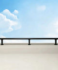 Height Increasing Balcony Railing Kit With Wall Extender For Low Walls delivers safety barrier with sturdy black railing against blue sky.