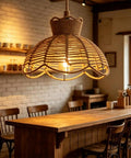 YNAHZAOK Hand-Woven Jute Rope Pendant Light Wrapped Iron Frame Hanging Lamp with Natural Hemp Rope Cord above wooden table.