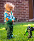 Child using GT3B 2.4Ghz 3 Channel RC Transmitter With GR3E Receiver For Cars And Boats LCD Screen AFHDS Remote outdoors