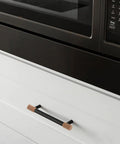 Brown Silicone Corner Guards For Furniture And Drawer Handles, soft round edge protectors on black drawer handle in kitchen.