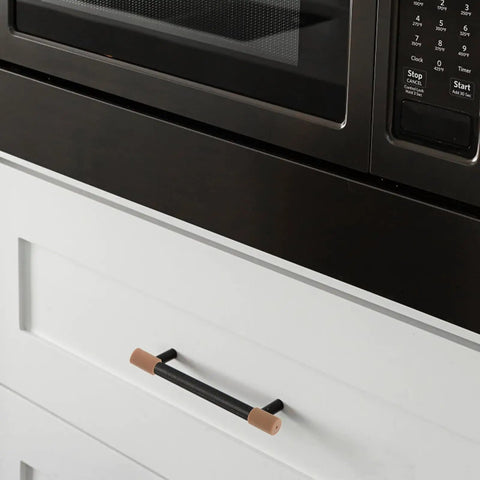 Brown Silicone Corner Guards For Furniture And Drawer Handles, soft round edge protectors on black drawer handle in kitchen.