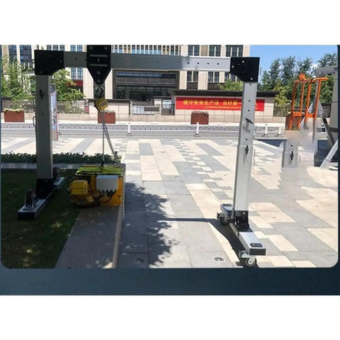 Real Deal Portable Gantry Crane With Electric Winch And Chain Ratchet, aluminum frame and electric winch on outdoor pavement.