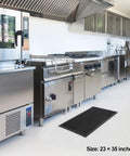 Heavy Duty Commercial Rubber Floor Mat Featuring Hexagonal Drainage Cutouts For Garage And Shop Kick Ass Non Slip Oil Grease Resistant Tough As Nails Level in kitchen with stainless appliances, 23x35 inches.