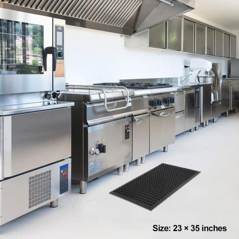 Heavy Duty Commercial Rubber Floor Mat Featuring Hexagonal Drainage Cutouts For Garage And Shop Kick Ass Non Slip Oil Grease Resistant Tough As Nails Level in kitchen with stainless appliances, 23x35 inches.