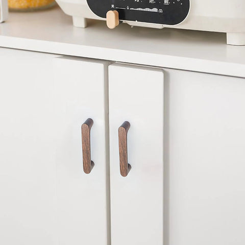 Front view of a white cabinet with Six Pack Walnut Wood Drawer Pulls Set Rustic Cabinet Handles For Kitchen And Furniture Hardware approximately 6.93 inch long.