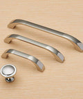 Brushed Nickel Cabinet Handles Three Pack With 64 Millimeter Hole Centers Euro Style Drawer Pulls in various sizes displayed on wood surface