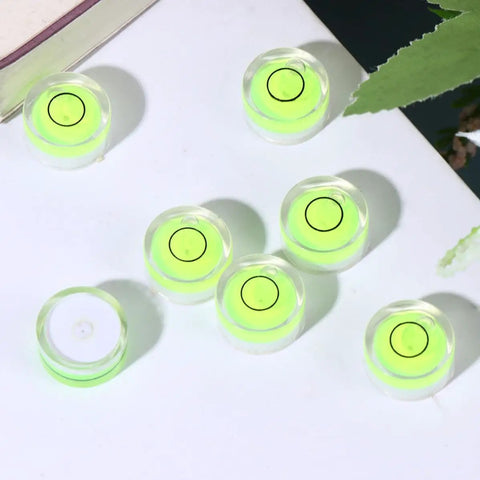 Ten Piece Circular Bubble Level Set Acrylic High Precision Spirit Levels For Calibrating Picture Frames And Cross Stitch Frames Easy To Use Measuring Tool For Accurate Horizontal Alignment on a table