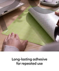 Person peeling back green mat showing Cutting Mat Variety Pack Four 12 By 24 Inch Mats For Crafting Workhorse Set With Light Grip