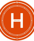 Foldable Outdoor Drone Landing Pad With H Mark And Direction Guides shown in high visibility orange for accurate landings.