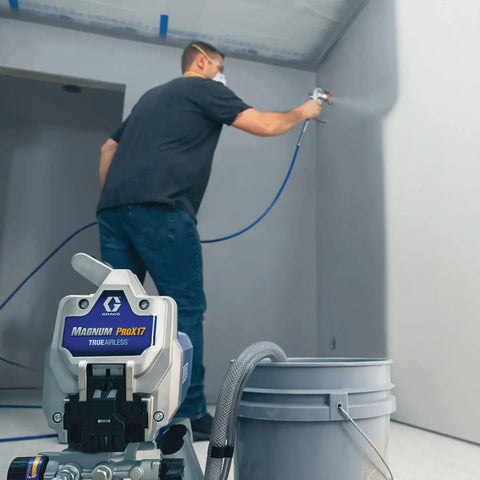 Pro Grade Airless Paint Sprayer With Fully Adjustable Pressure and a rugged stainless steel piston pump in use on a wall.