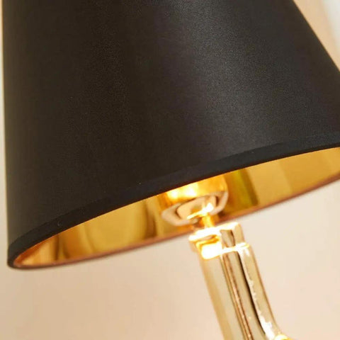 Close-up of Gold Gun Desk Light With Linen Shade, showing gold metal body and black shade detail, Nordic Metal Craft design.