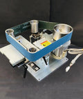 Heavy Duty 750W Brushless Belt Grinder A Real Garage Workhorse Built Tough In Rock Solid Steel Frame Forward Reverse Toggle Versatile Benchtop Sander And Polishing Kit mounted on a flat surface showing motor and belt setup.