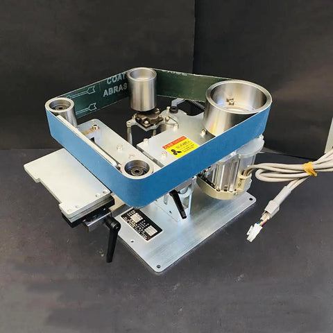 Heavy Duty 750W Brushless Belt Grinder A Real Garage Workhorse Built Tough In Rock Solid Steel Frame Forward Reverse Toggle Versatile Benchtop Sander And Polishing Kit mounted on a flat surface showing motor and belt setup.