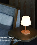 Cordless USB Rechargeable Table Lamp With 4000mAh Battery, 2700K Warm LED, on a wooden table beside a sofa