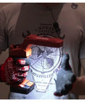 Person holding cordless LED flexible head work light with 500 lumens, illustrating portability and compact design for workshops and DIY projects.