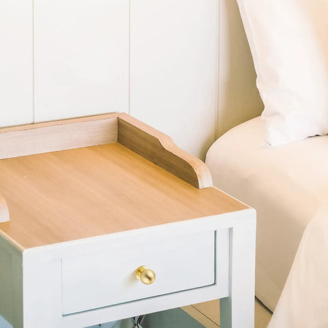 Round Ball Cabinet Knobs For Dresser And Kitchen, Brushed Brass 0.95 Inch Diameter, installed on a white nightstand drawer.