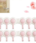 Hassle Free Peel And Stick Wall Hooks With Six Swiveling Rotating Arms For Hanging Bath Towels Kitchen Tools And Daily Gear Directly On Any Smooth Surface, featuring pink hooks on a white adhesive base.