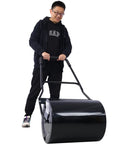 Beefy Pro Grade Lawn Roller For Smooth Lawns Push Or Tow Design with 48.5 Inch Height 16 Gallon Drum in use by man, black steel.