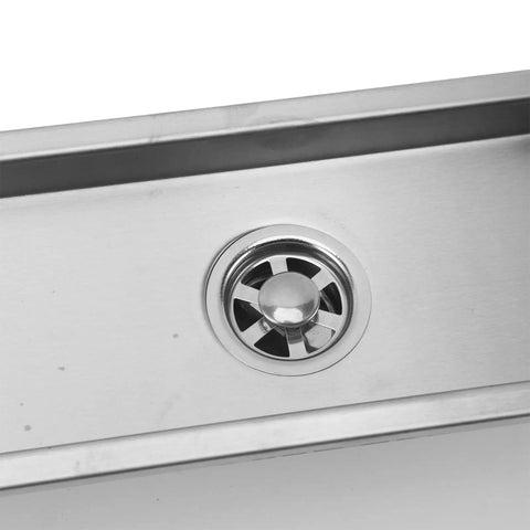 Close-up of the Oreilet Linear Shower Drain 12 Inch Floor Drain with Hair Catcher featuring a stainless steel grate and drain hole.