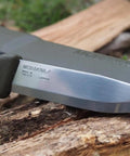 Companion Carbon Steel Fixed Blade Knife With Sheath 4.1 Inch Blade Military Green resting on wood