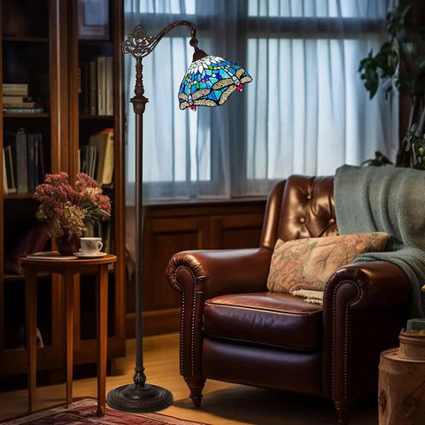 Dope Tiffany Style Stained Glass Floor Lamp With Sea Blue Dragonfly Pattern, 62 Inch Tall Industrial Dark Bronze Pole, 11 Inch Wide Shade, Ideal Reading Lamp For Living Room, Bedroom, Office Or Study next to leather armchair in cozy room