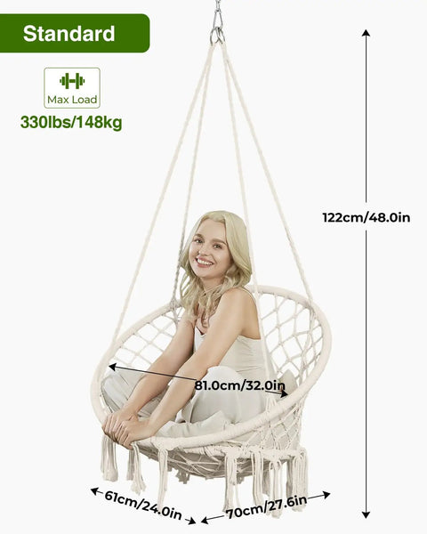 Woman sitting in Macrame Hammock Chair With Super Comfy Cloud Cushion, Boho Hanging Swing for indoor outdoor relaxation, beige.