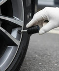 Heavy Duty 4 Pack Tire Valve Stem Caps For Tesla Cybertruck 2024 Through 2026 being installed on a wheel valve.