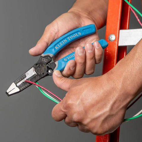 Person using heavy duty wire cutters with lock and built-in wire stripper on red ladder, 8 to 18 AWG solid and 10 to 20 AWG stranded.