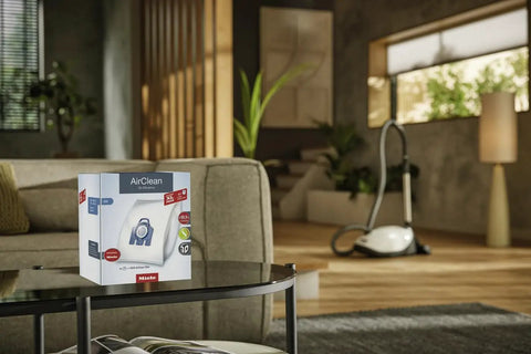 AirClean 3D Efficiency Dust Bags Type GN Allergy XL Pack in living room with vacuum cleaner in background