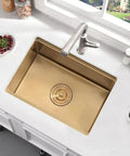 Gold undermount bar sink with single bowl and faucet on white counter, kitchen view, home decor