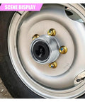 Pair Of 1.98 Inch Trailer Axle Wheel Hub Bearing Dust Caps Forged From Tough Galvanized Steel and secure rubber plugs on a wheel.