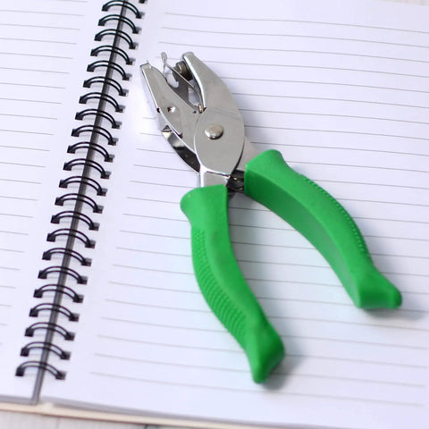 Two Pack Grab-and-Go Handheld Circle Hole Puncher Set 1/4 And 1/8 Inch For Craft Paper And DIY Projects, green grips on notebook.