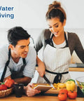 Couple preparing vegetables in kitchen, promoting Whole House Water Filtration Kit With Built In Bypass Valve for healthy living.