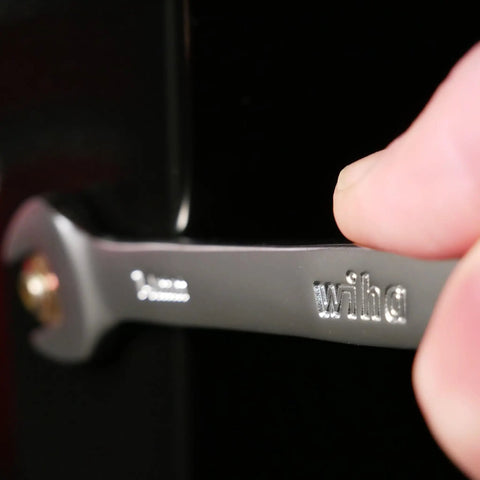 Close-up of a hand using a chrome vanadium wrench from 12 Piece Metric Wrench Set For Pro Mechanics, comfort grip handle visible.