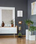 Versailles Floor Lamp With Built-In Shelves, 57.5 Inch Matte Black, White Linen Shade in modern living room setting